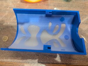 The inside front half of a blue tiki shade showing the shade curved around and inserted. 