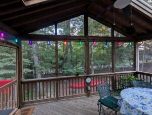 A view of the inside of the screened in deck, showing the eight tiki lights. 