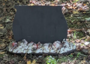 Black plywood cauldron silhouette and fake hot coals (painted crack filler foam with embedded lights).